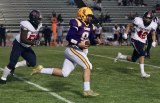 Lemoore's Donovan Lima runs for a short gain in the first quarter of the Tigers' football opener against visiting Memorial High School held Thursday night in Tiger Stadium.